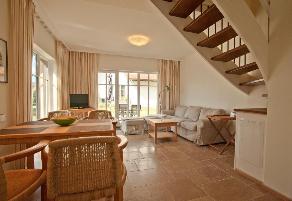 a living room with a table and a couch at Ferienhäuser Südwind in Hiddensee