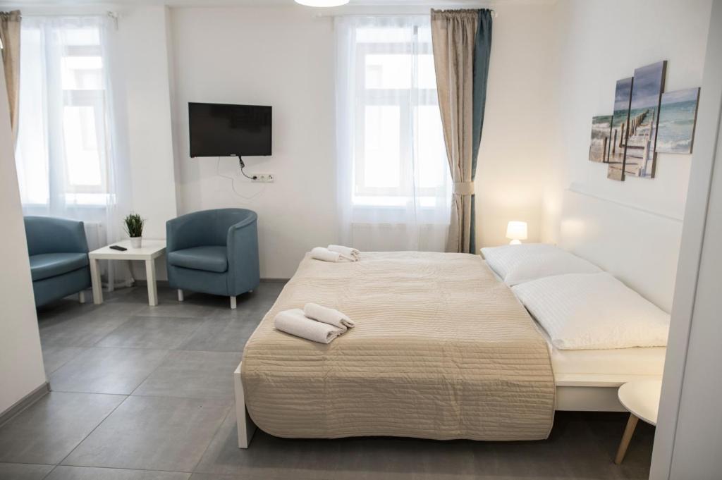 Postel nebo postele na pokoji v ubytování Rezidence Černý medvěd