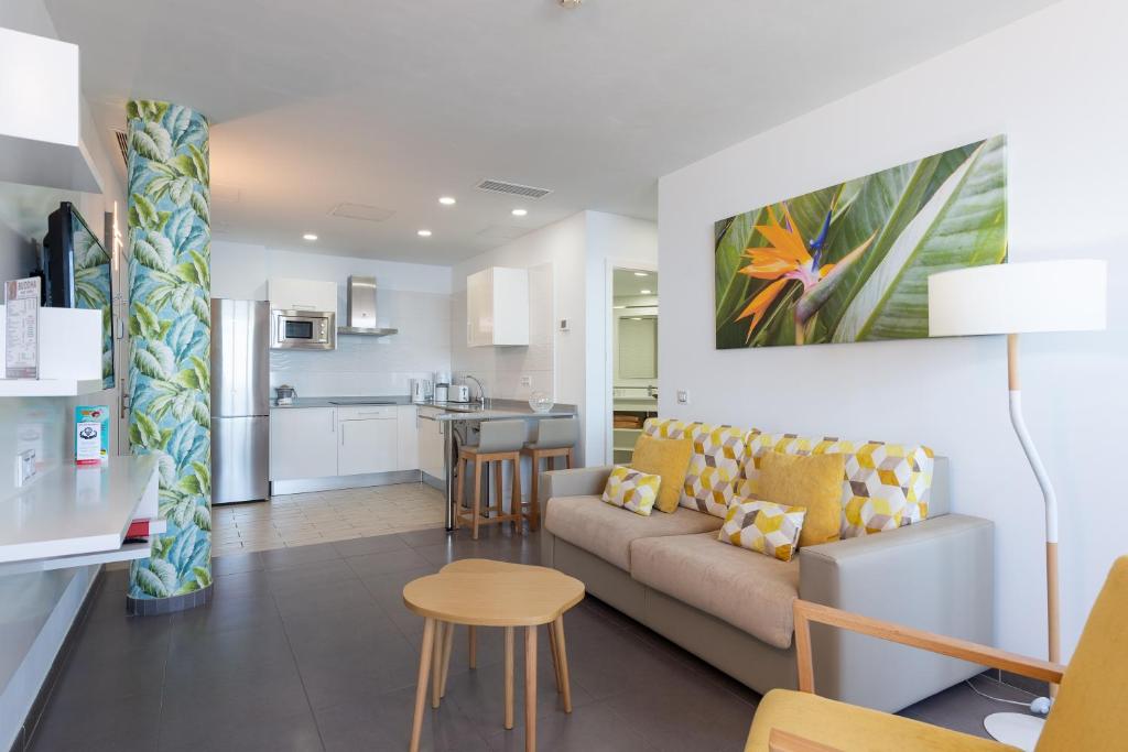a living room and kitchen with a couch and a table at Holiday Club Vista Amadores in Amadores