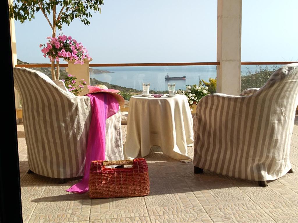 a table and two chairs with a table and a table and chairs at New Country House Salvia in Sitia