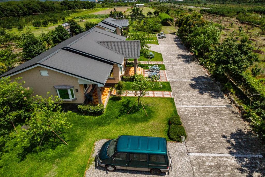 an aerial view of a house with a van parked in the yard at Countryside B&amp;B in Ruisui