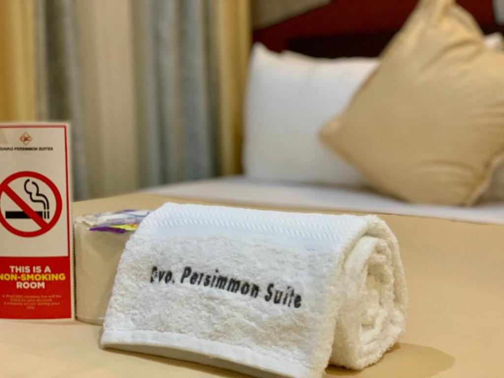 Postel nebo postele na pokoji v ubytování Davao Persimmon Suites