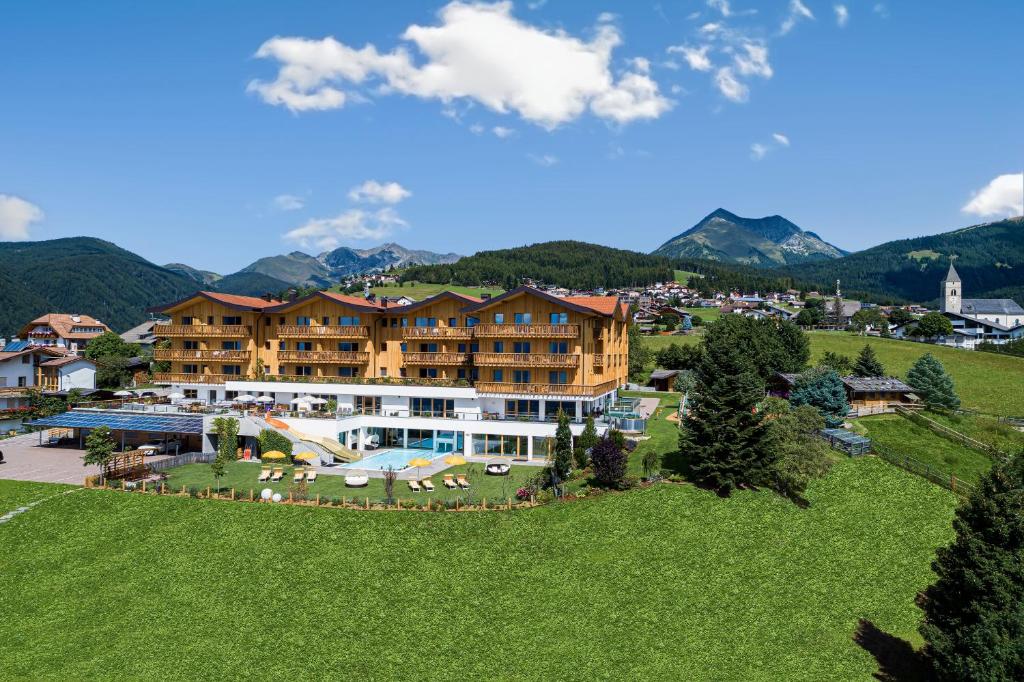 an aerial view of a resort with mountains in the background at Family Home Alpenhof in Maranza