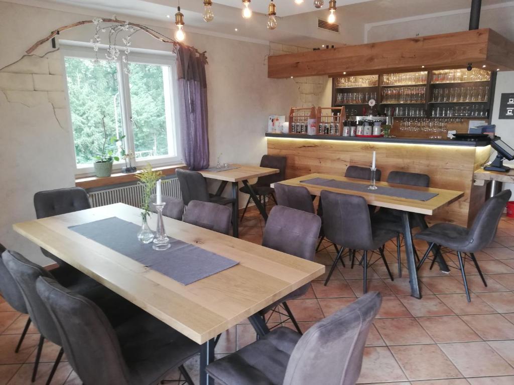 a dining room with wooden tables and chairs at Waldgasthaus in Hochburg