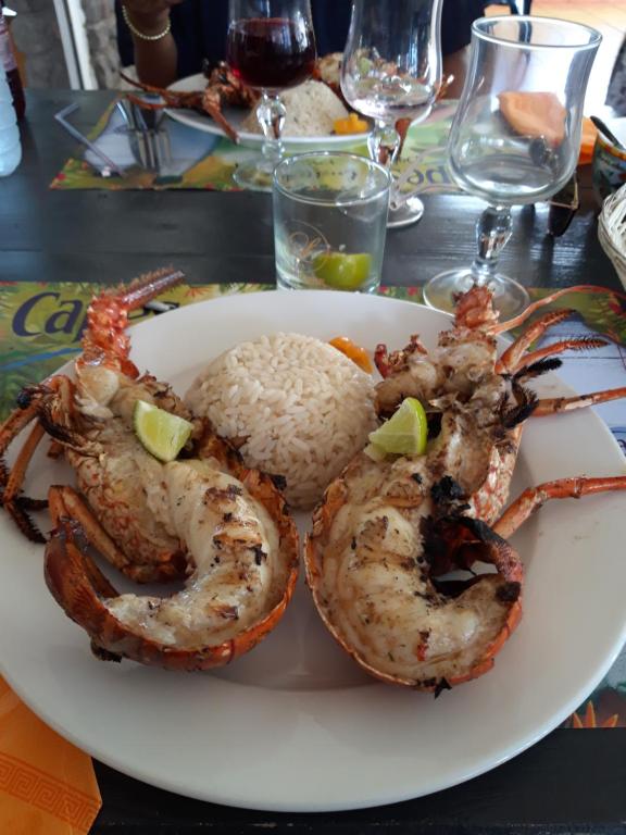 a plate of shrimp and rice on a table at Fetay Jaune in Baie-Mahault