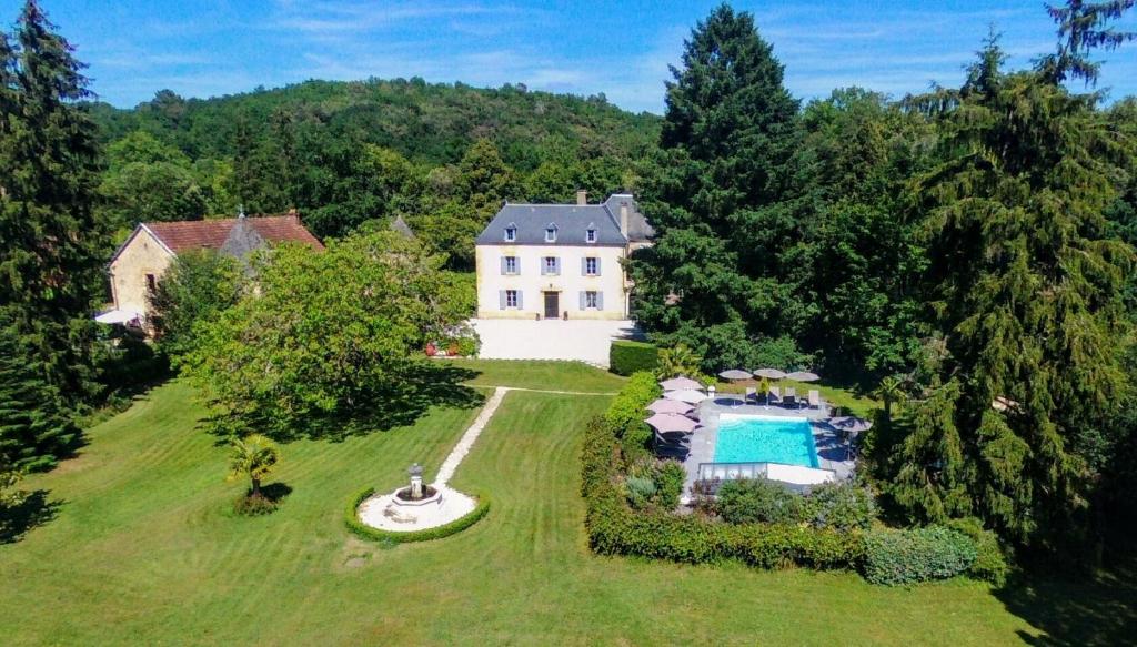 an aerial view of a large house with a swimming pool at Le Petit Manoir de Vitrac in Vitrac