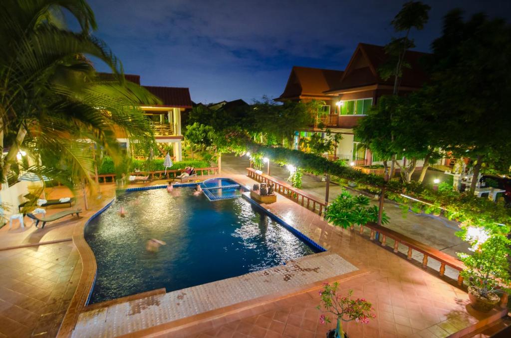 an indoor pool in a resort at night at Avila Resort Pattaya in Jomtien Beach