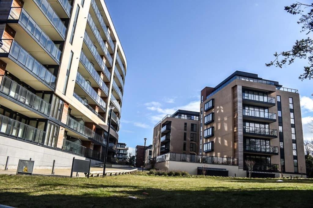 two tall buildings in a city with a grass field at The Grange in Dublin