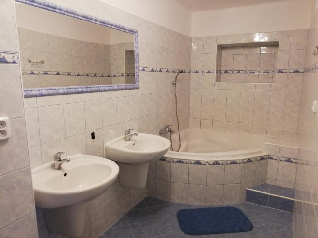 a bathroom with a sink and a toilet and a tub at Chata Černá v Pošumaví in Černá v Pošumaví