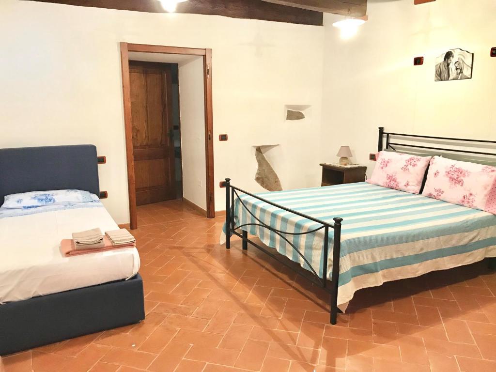 Postel nebo postele na pokoji v ubytování Agriturismo podere Casano