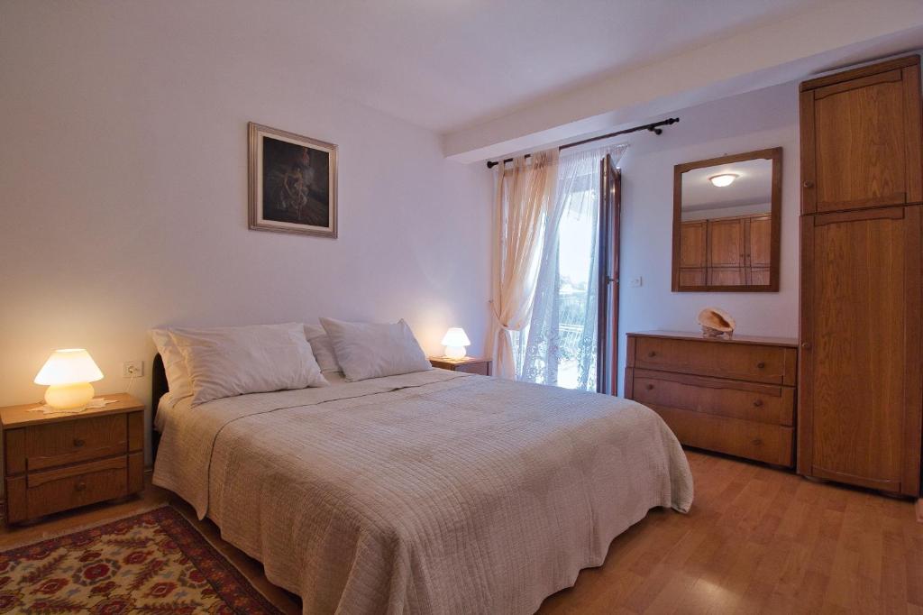 Postel nebo postele na pokoji v ubytování Apartments SI