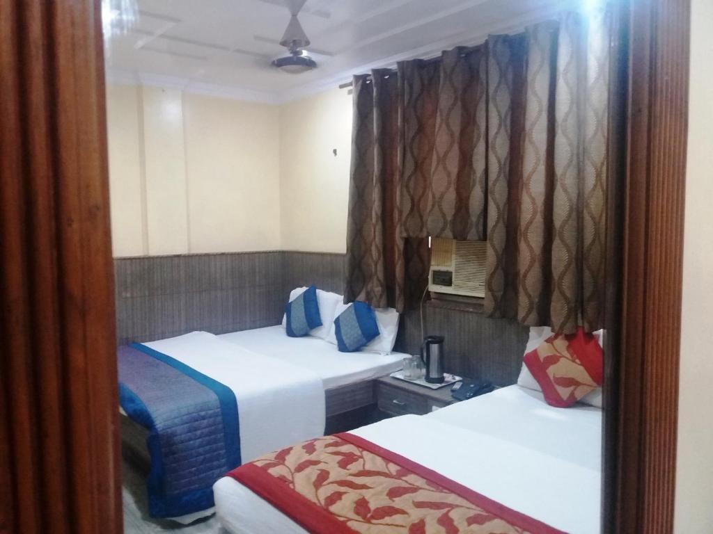 une chambre d'hôtel avec 2 lits dans l'établissement Hotel Roma Villa, à New Delhi
