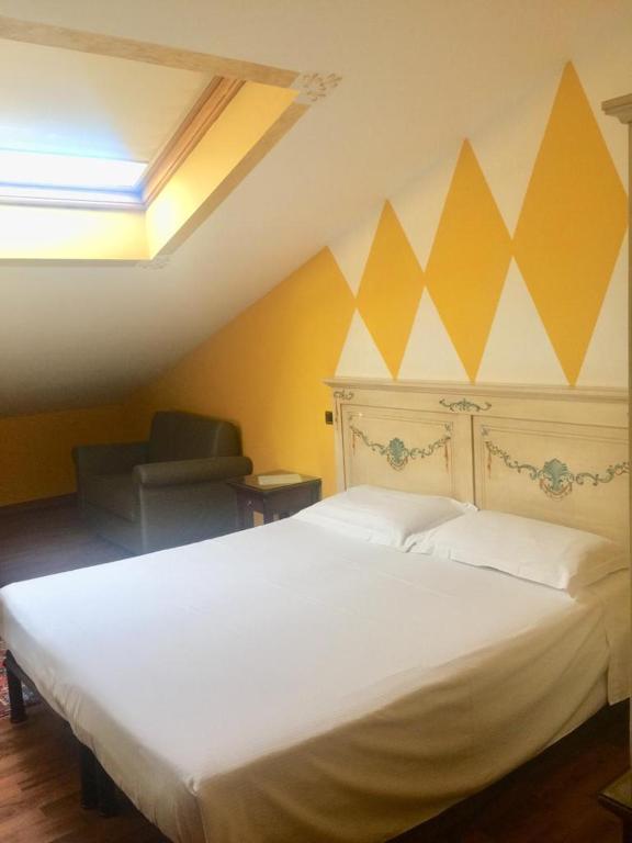 Postel nebo postele na pokoji v ubytování Hotel La Loggia