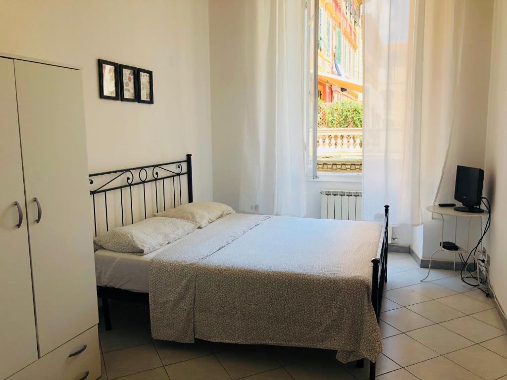 um quarto com uma cama, uma janela e uma televisão em Cinque terre SUITE em La Spezia
