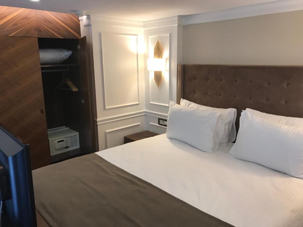 a bedroom with a large bed with white pillows at Old Port Hotel Suit in Istanbul