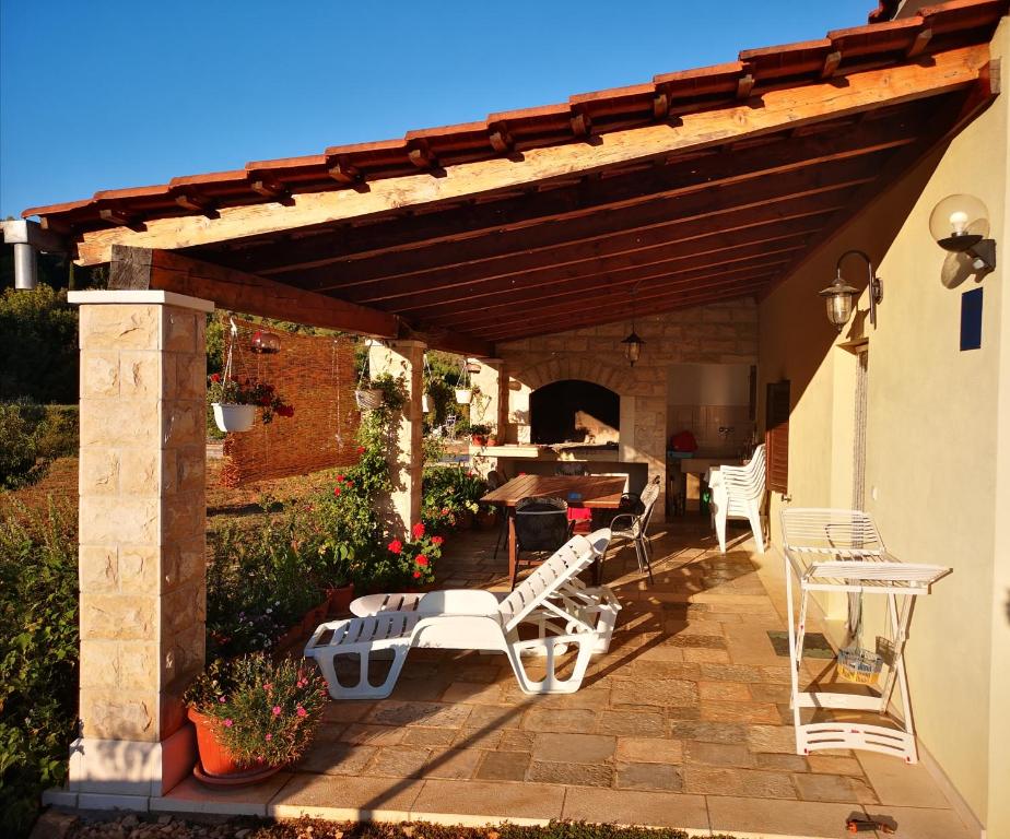 a patio with chairs and a table and a table and chairs at Holiday Home Cvitka in Vis
