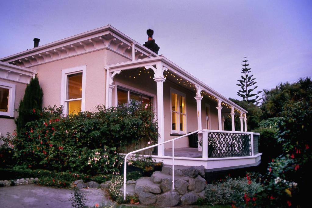 a pink house with a person on top of it at The Point B&B in Kaikoura