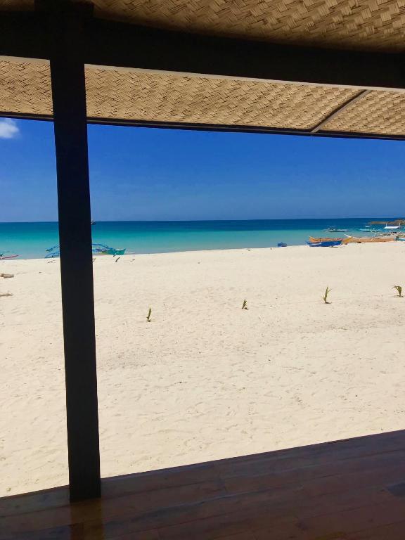 a view of a beach from a window at Fisherman's Cottage El Nido in El Nido