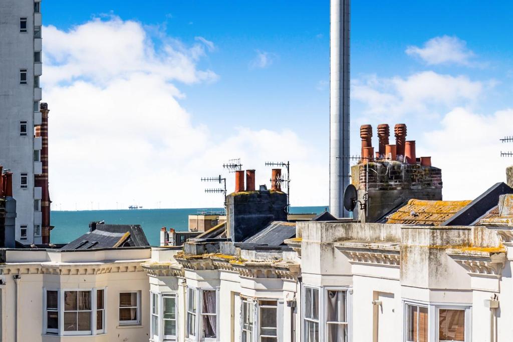 a group of buildings with a factory in the background at The i360 flat, penthouse, sea view, large private roof terrace, central Brighton 2 bedroom, up to 6 guests in Brighton & Hove