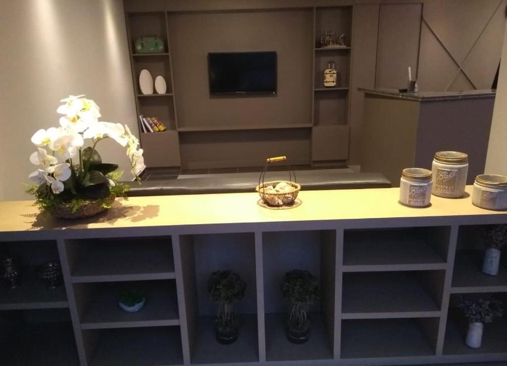 a room with a table with flowers on it at Ilhabela Park Hotel in Brasília