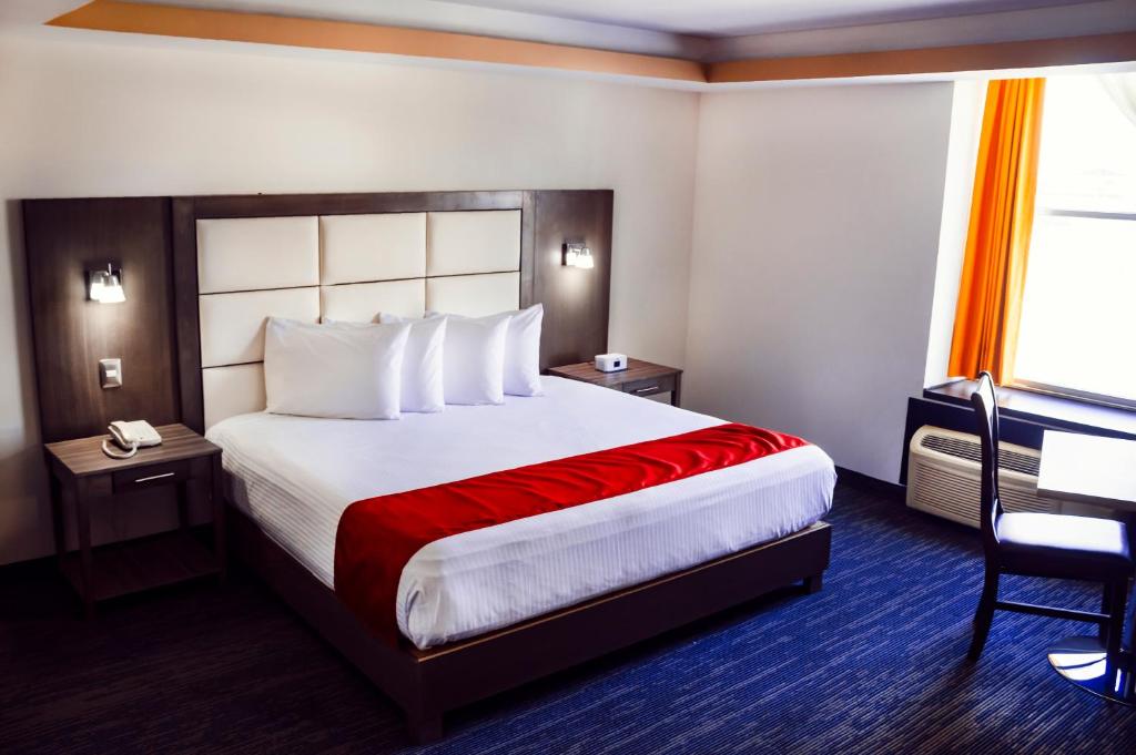 a hotel room with a large bed and a desk at Hotel ALO! Express in Torreón
