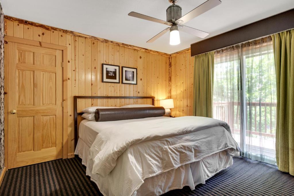 a bedroom with a bed and a ceiling fan at 3 Peaks Resort & Beach Club in South Lake Tahoe