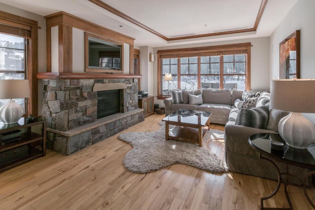 a living room with a couch and a fireplace at Luxury 4BD Village at Northstar Residence - Iron Horse South 412 in Truckee