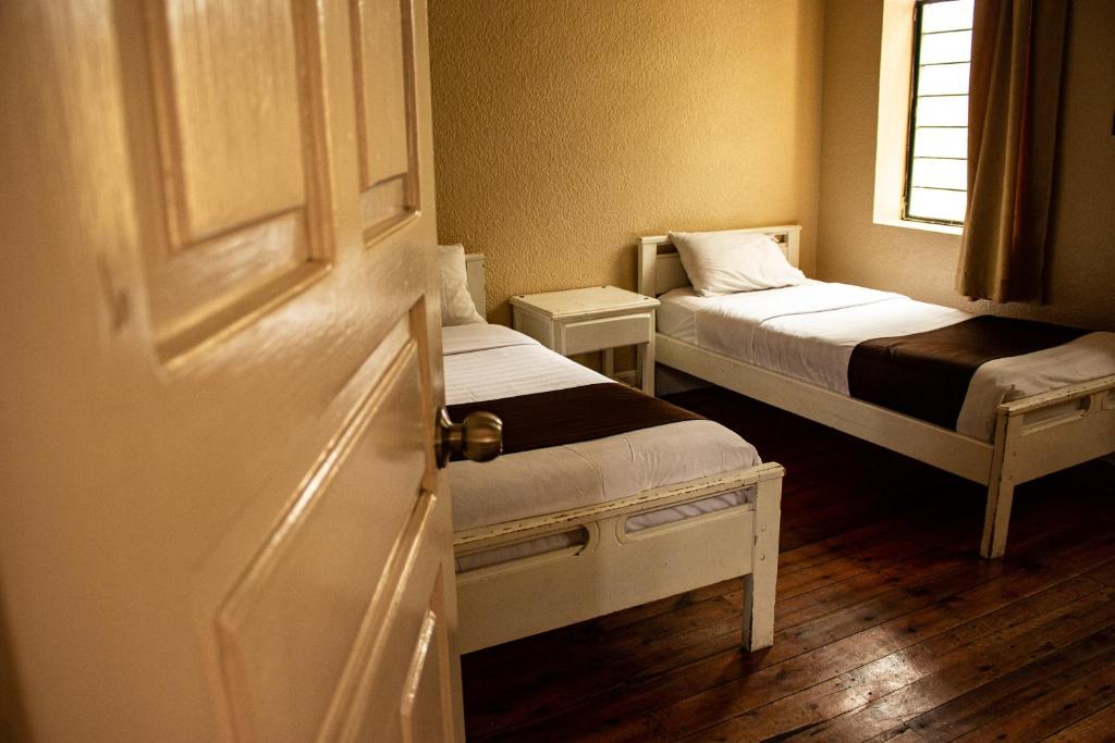 Postel nebo postele na pokoji v ubytování Hostal Loro Verde