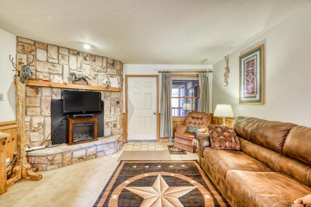 a living room with a couch and a fireplace at Snowfire 209B in Angel Fire
