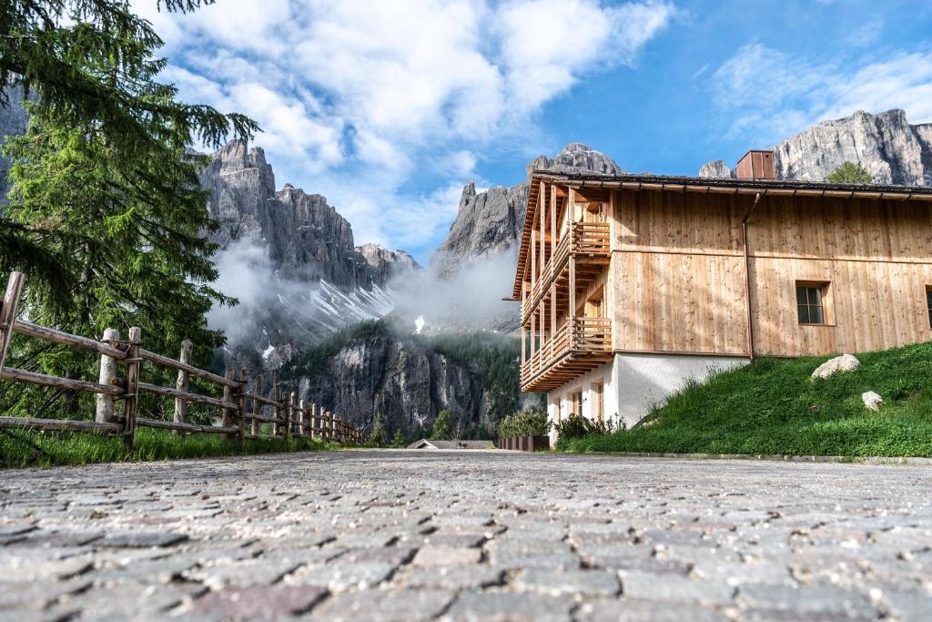 a stone road in front of a mountain at Chalet Cogolara in Colfosco
