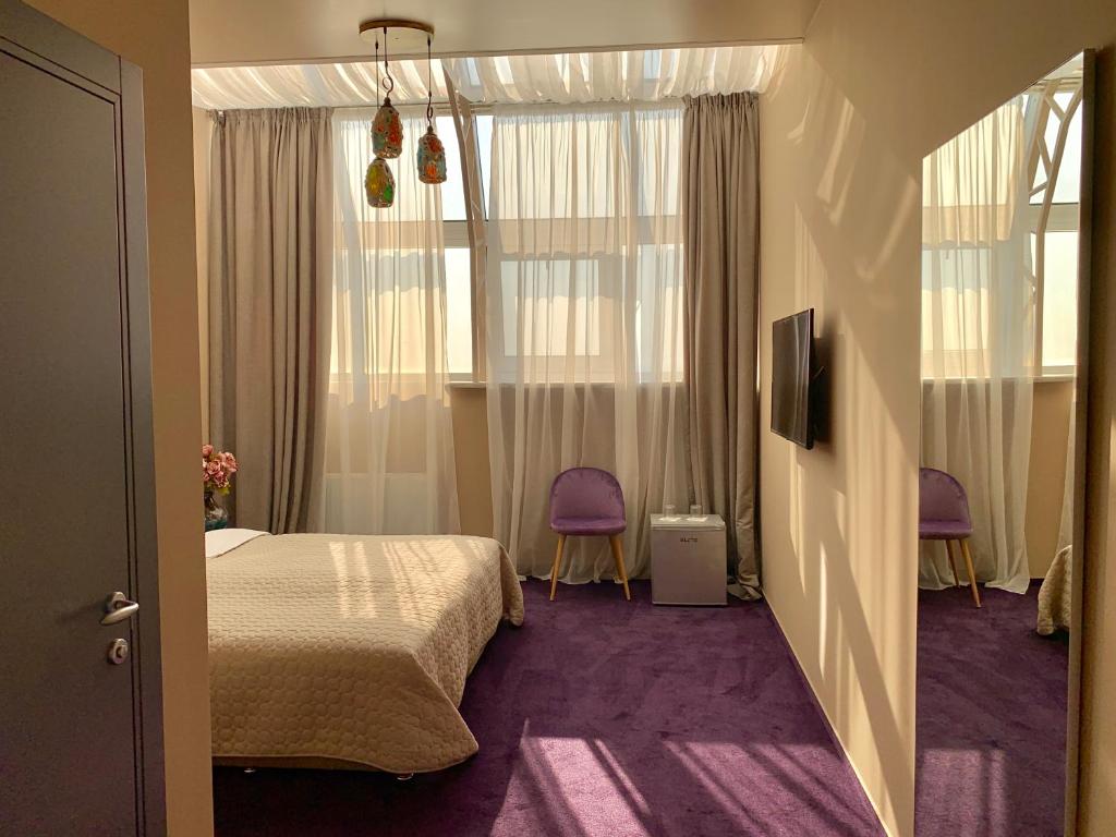 Postel nebo postele na pokoji v ubytování Horizon Hotel