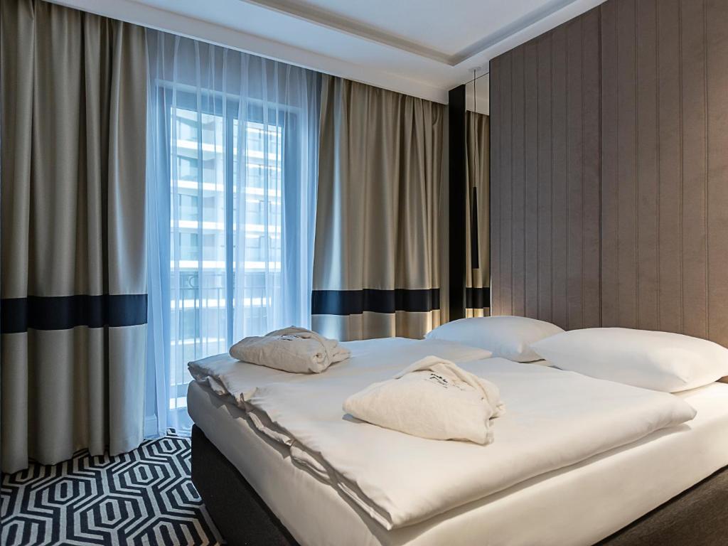 Postel nebo postele na pokoji v ubytování VacationClub – Baltic Park Fort Apartament F.311