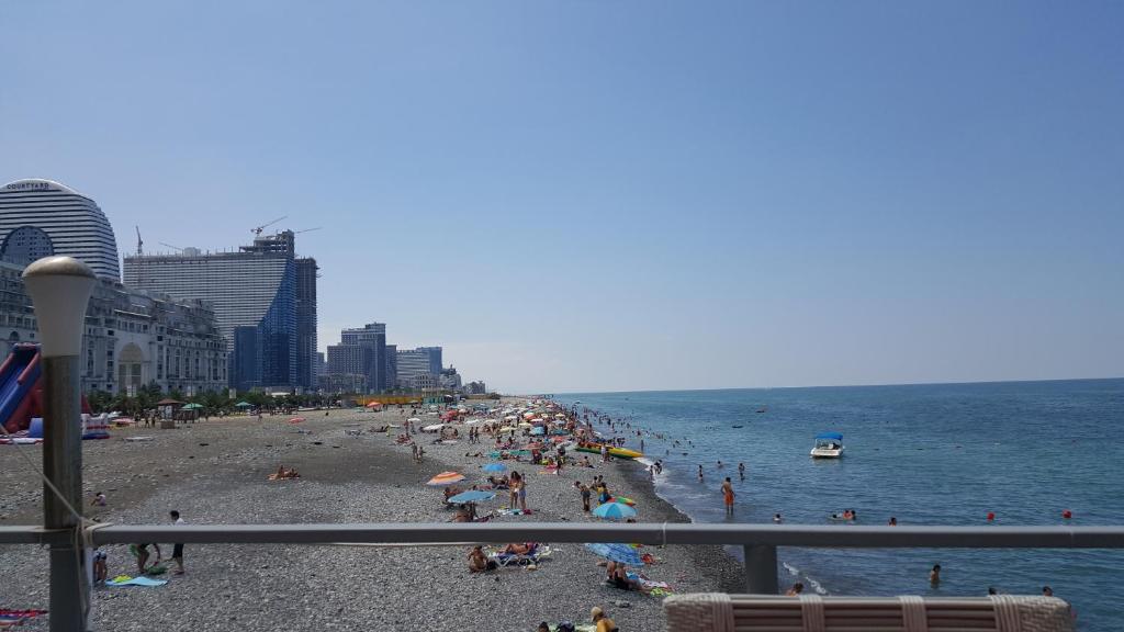 a group of people on a beach near the water at Subtropic City in Batumi