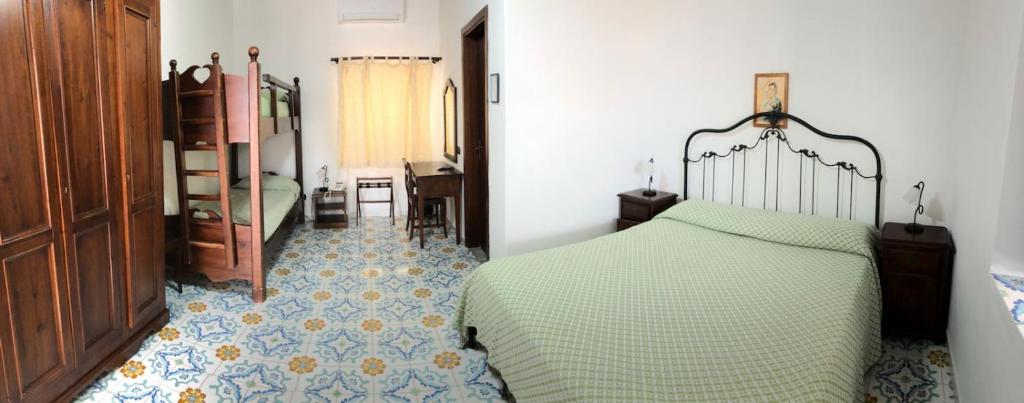 a bedroom with a bed and a room with a desk at Hotel Villaggio Stromboli - isola di Stromboli in Stromboli