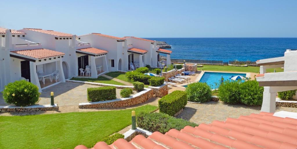 a villa with a view of the ocean at Binibeca Beach Villas in Binibeca