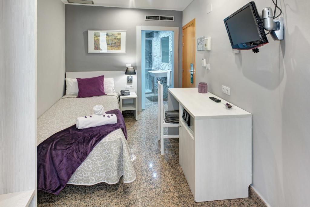 A bed or beds in a room at Hotel Nuevo Triunfo