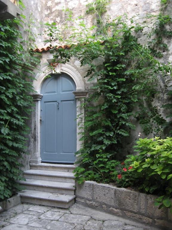a blue door on the side of a building with stairs at Giunio house, Old town centre in Korčula