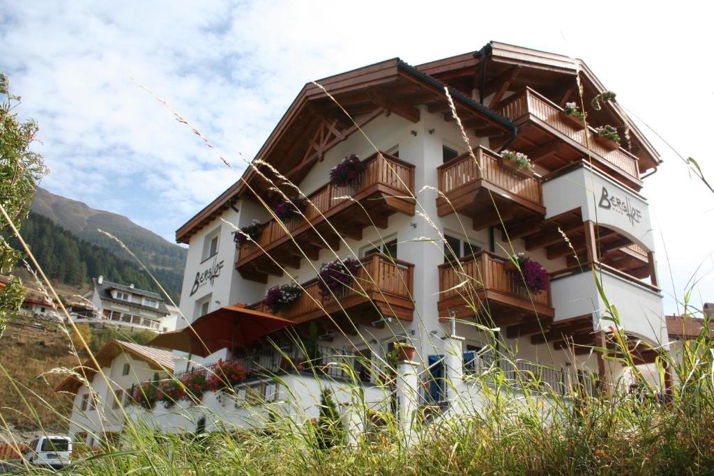 a building with balconies on the side of it at Hotel Berghof in Nauders