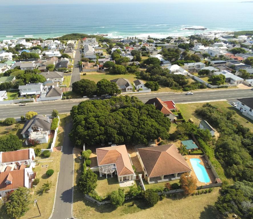 an aerial view of a suburb with houses and the ocean at Milkwood Lodge in Hermanus