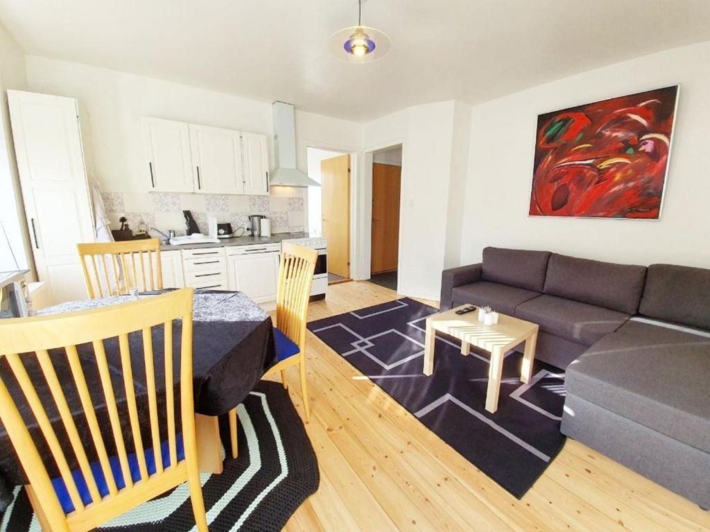 a living room with a couch and a table at Struer Town Apartment in Struer