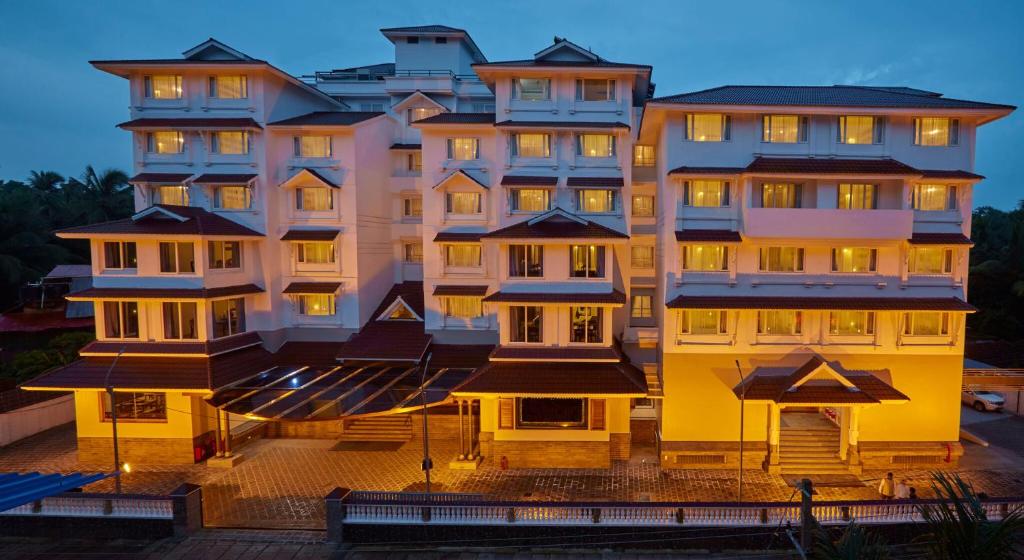 a large building with lights on in front of it at Sterling Guruvayur in Guruvāyūr