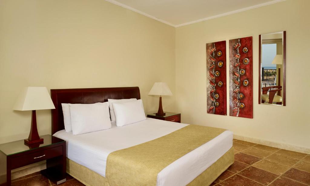 A bed or beds in a room at Coral Sea Beach and Aqua Park