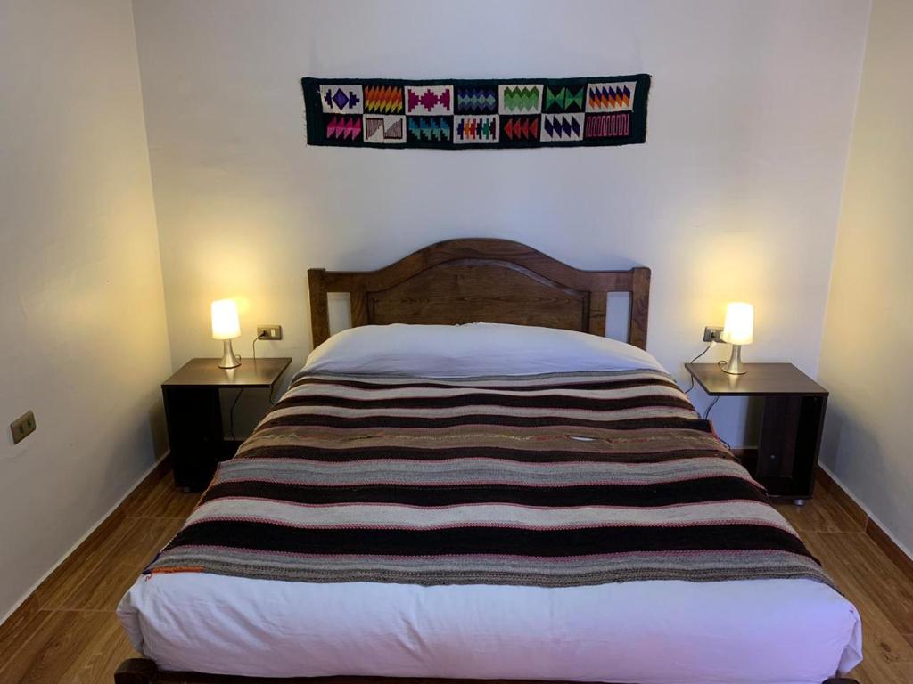Postel nebo postele na pokoji v ubytování Hostal Nuevo Amanecer