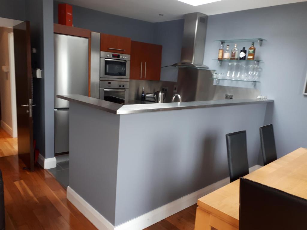 a kitchen with stainless steel appliances and a counter at Luxurious Penthouse Apartment 1 , City Centre in Kilkenny