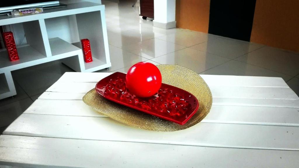 a hat with a red heart on top of a table at House Cidadela in Praia