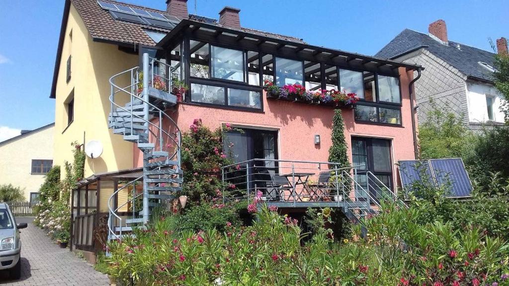 a house with a spiral staircase in front of it at Ferienwohnung Blütentraum in Kirchenlamitz