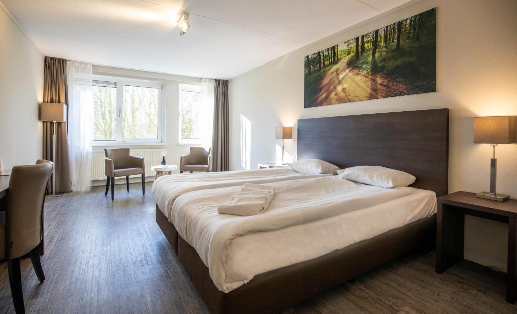 Postel nebo postele na pokoji v ubytování Fletcher Hotel Landgoed Avegoor