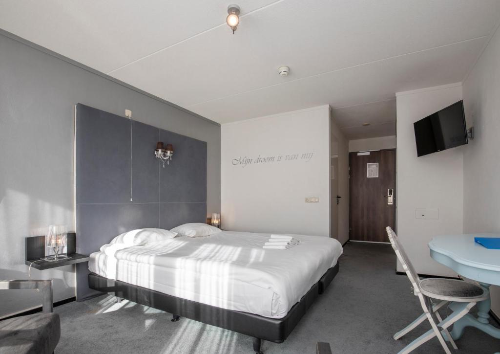 Postel nebo postele na pokoji v ubytování Fletcher Hotel Landgoed Avegoor