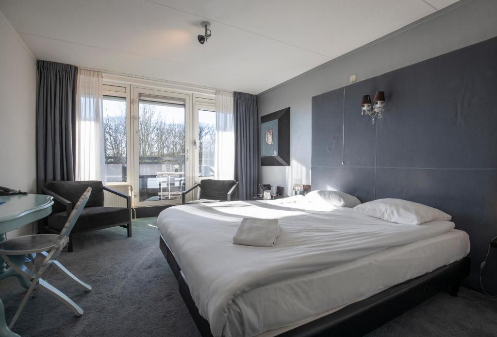 Postel nebo postele na pokoji v ubytování Fletcher Hotel Landgoed Avegoor