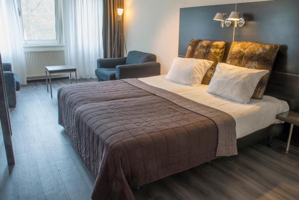 Postel nebo postele na pokoji v ubytování Fletcher Hotel Landgoed Avegoor
